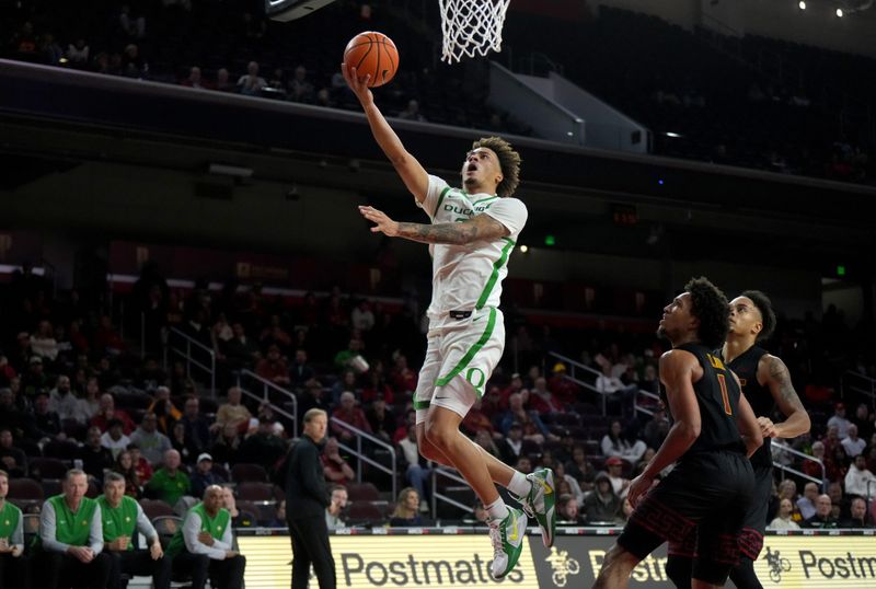 Dec 4, 2024; Los Angeles, California, USA; Oregon Ducks guard Jadrian Tracey (2) shoots against Southern California Trojans guard Desmond Claude (1) in the second half at Galen Center. Mandatory Credit: Kirby Lee-Imagn Images