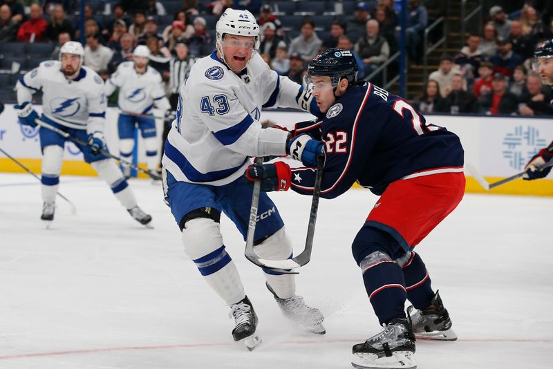 Feb 10, 2024; Columbus, Ohio, USA; Columbus Blue Jackets defenseman Jake Bean (22) checks Tampa Bay Lightning defenseman Darren Raddysh (43) during the first period at Nationwide Arena. Mandatory Credit: Russell LaBounty-USA TODAY Sports