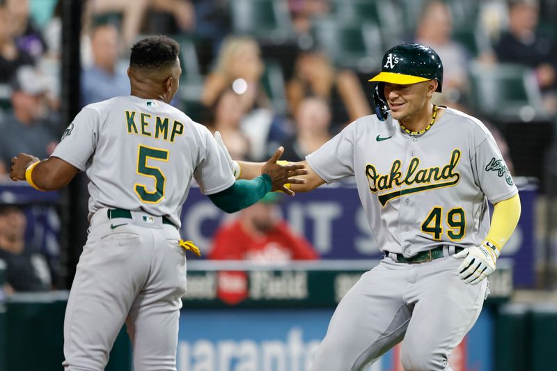 Aug 25, 2023; Chicago, Illinois, USA; Oakland Athletics first baseman Ryan Noda (49) celebrates with second baseman Tony Kemp (5) after hitting a solo home run against the Chicago White Sox during the seventh inning at Guaranteed Rate Field. Mandatory Credit: Kamil Krzaczynski-USA TODAY Sports