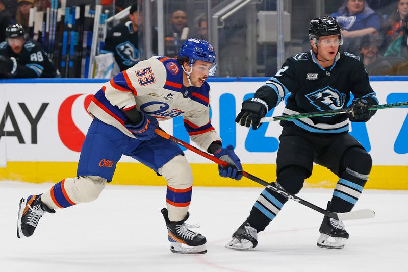 Oct 28, 2025; Edmonton, Alberta, CAN; Edmonton Oilers forward Issac Howard (53) and Utah Mammoth defensemen Olli Maatta (2) chases a loose puck during the first period at Rogers Place. Mandatory Credit: Perry Nelson-Imagn Images