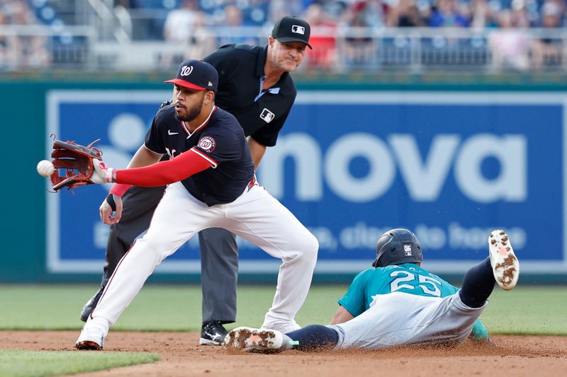 May 24, 2024; Washington, District of Columbia, USA; Seattle Mariners shortstop Dylan Moore (25) steals second base ahead of a tag by Washington Nationals second baseman Luis García Jr. (2) during the third inning at Nationals Park. Mandatory Credit: Geoff Burke-USA TODAY Sports