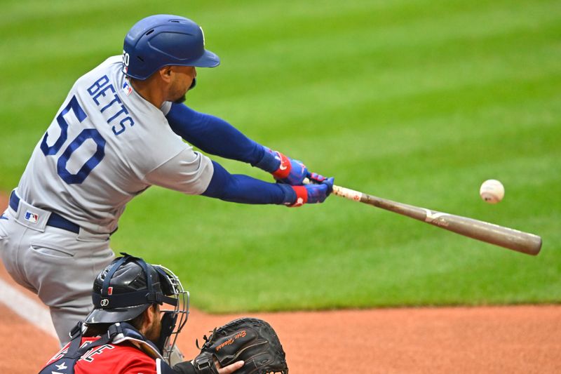 Aug 23, 2023; Cleveland, Ohio, USA; Los Angeles Dodgers right fielder Mookie Betts (50) singles in the first inning against the Cleveland Guardians at Progressive Field. Mandatory Credit: David Richard-USA TODAY Sports