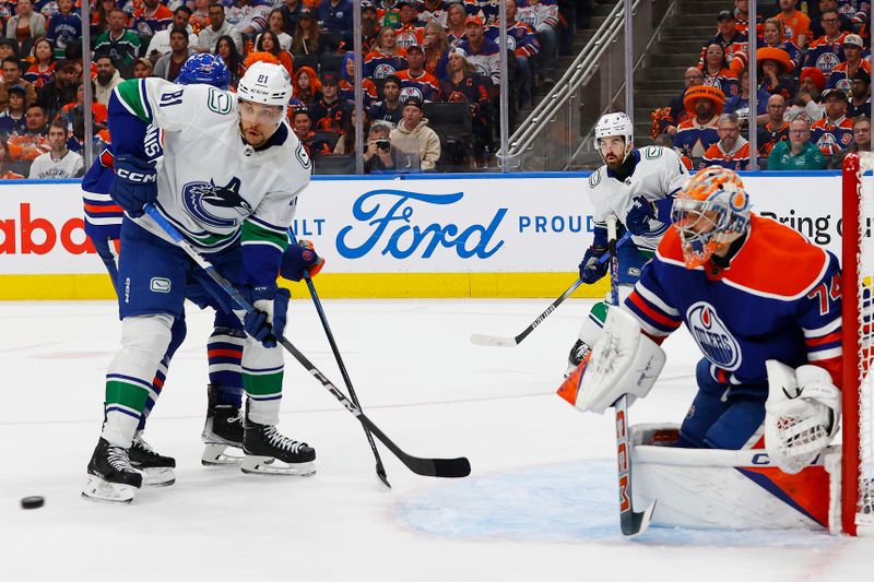 May 12, 2024; Edmonton, Alberta, CAN; Vancouver Canucks forward Dakota Joshua (81) looks for a loose puck in front of Edmonton Oilers goaltender Stuart Skinner (74) during the second period in game three of the second round of the 2024 Stanley Cup Playoffs at Rogers Place. Mandatory Credit: Perry Nelson-USA TODAY Sports