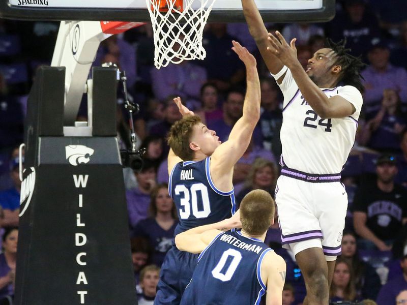 Feb 24, 2024; Manhattan, Kansas, USA; Kansas State Wildcats forward Arthur Maluma (24) makes a layup against Brigham Young Cougars guard Dallin Hall (30) and forward Noah Waterman (0) during the second half at Bramlage Coliseum. Mandatory Credit: Scott Sewell-USA TODAY Sports