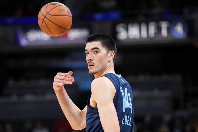 INDIANAPOLIS, INDIANA - OCTOBER 14: Zach Edey #14 of the Memphis Grizzlies passes the ball in the first quarter against the Indiana Pacers during a preseason game at Gainbridge Fieldhouse on October 14, 2024 in Indianapolis, Indiana. NOTE TO USER: User expressly acknowledges and agrees that, by downloading and or using this photograph, User is consenting to the terms and conditions of the Getty Images License Agreement. (Photo by Dylan Buell/Getty Images)