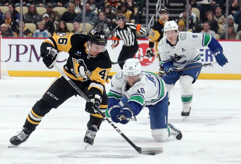 Nov 27, 2024; Pittsburgh, Pennsylvania, USA;  Pittsburgh Penguins center Blake Lizotte (46) moves the puck up ice as Vancouver Canucks center Elias Pettersson (40) and right wing Conor Garland (8) chase during the third period at PPG Paints Arena. Mandatory Credit: Charles LeClaire-Imagn Images