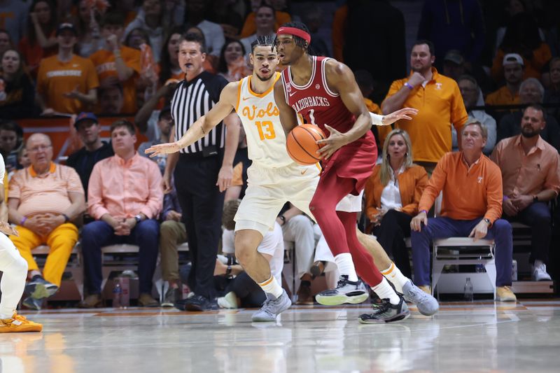 Feb 28, 2023; Knoxville, Tennessee, USA; Tennessee Volunteers forward Olivier Nkamhoua (13) defends Arkansas Razorbacks guard Ricky Council IV (1) during the first half at Thompson-Boling Arena. Mandatory Credit: Randy Sartin-USA TODAY Sports