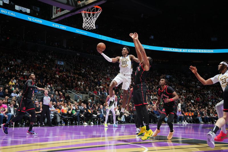 TORONTO, CANADA - DECEMBER 3: Bennedict Mathurin #00 of the Indiana Pacers drives to the basket during the game against the Toronto Raptors during the Emirates NBA Cup game on December 3, 2024 at the Scotiabank Arena in Toronto, Ontario, Canada.  NOTE TO USER: User expressly acknowledges and agrees that, by downloading and or using this Photograph, user is consenting to the terms and conditions of the Getty Images License Agreement.  Mandatory Copyright Notice: Copyright 2024 NBAE (Photo by Mark Blinch/NBAE via Getty Images)