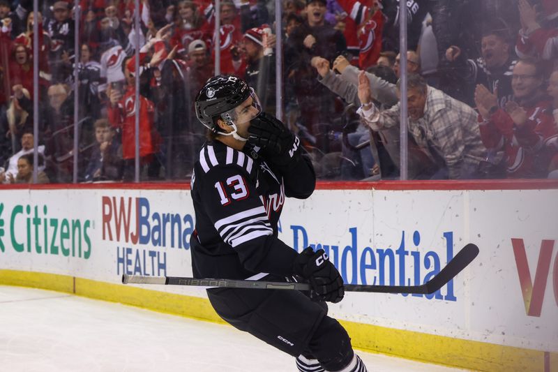 Nov 25, 2024; Newark, New Jersey, USA; New Jersey Devils center Nico Hischier (13) celebrates his goal against the Nashville Predators during the second period at Prudential Center. Mandatory Credit: Ed Mulholland-Imagn Images