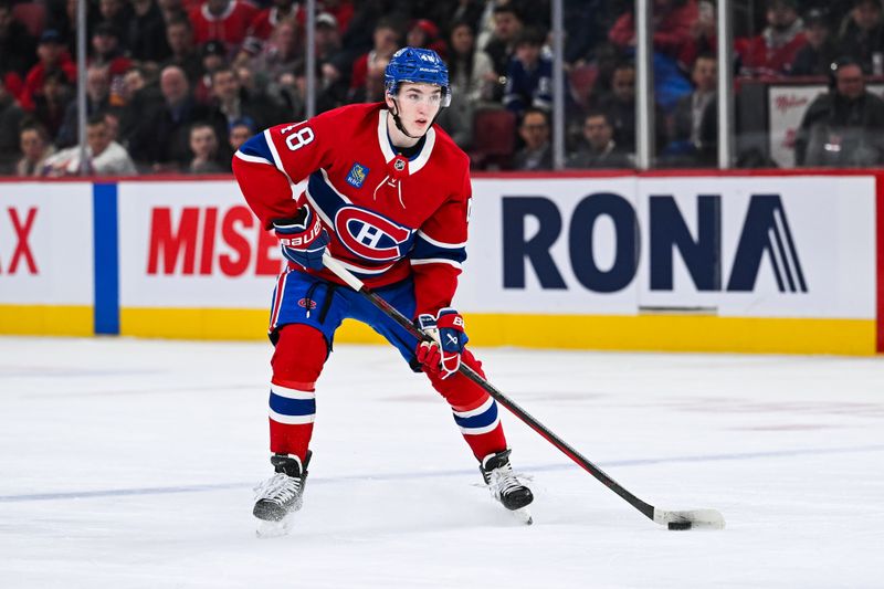 Jan 21, 2025; Montreal, Quebec, CAN; Montreal Canadiens defenseman Lane Hutson (48) plays the puck against the Tampa Bay Lightning during the first period at Bell Centre. Mandatory Credit: David Kirouac-Imagn Images