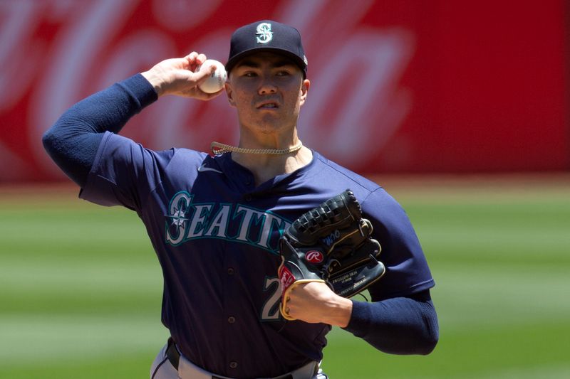 Jun 6, 2024; Oakland, California, USA; Seattle Mariners starting pitcher Bryan Woo (22) delivers a pitch against the Oakland Athletics during the first inning at Oakland-Alameda County Coliseum. Mandatory Credit: D. Ross Cameron-USA TODAY Sports