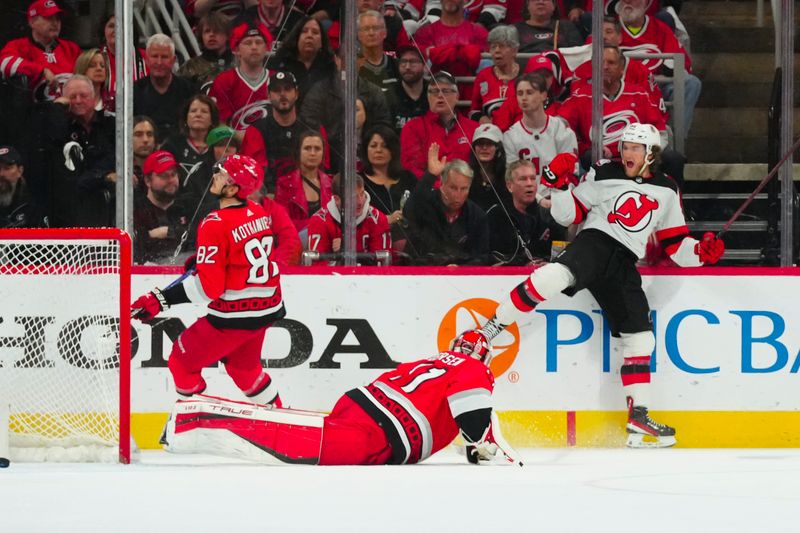 May 11, 2023; Raleigh, North Carolina, USA; New Jersey Devils center Dawson Mercer (91) scores past Carolina Hurricanes goaltender Frederik Andersen (31) during the first period in game five of the second round of the 2023 Stanley Cup Playoffs at PNC Arena. Mandatory Credit: James Guillory-USA TODAY Sports