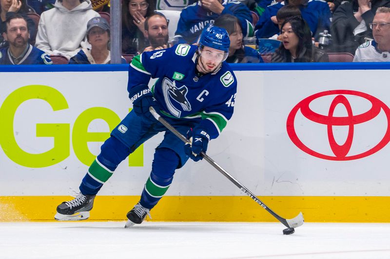 May 8, 2024; Vancouver, British Columbia, CAN; Vancouver Canucks defenseman Quinn Hughes (43) handles the puck against the Edmonton Oilers during the third period in game one of the second round of the 2024 Stanley Cup Playoffs at Rogers Arena. Mandatory Credit: Bob Frid-USA TODAY Sports