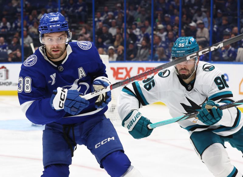 Dec 5, 2024; Tampa, Florida, USA; Tampa Bay Lightning left wing Brandon Hagel (38) and San Jose Sharks defenseman Jake Walman (96) skates during the third period at Amalie Arena. Mandatory Credit: Kim Klement Neitzel-Imagn Images