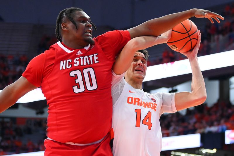 Feb 14, 2023; Syracuse, New York, USA; North Carolina State Wolfpack forward D.J. Burns Jr. (30) fouls Syracuse Orange center Jesse Edwards (14) on a shot attempt during the first half at the JMA Wireless Dome. Mandatory Credit: Rich Barnes-USA TODAY Sports