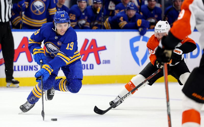 Apr 5, 2024; Buffalo, New York, USA;  Buffalo Sabres center Peyton Krebs (19) controls the puck as Philadelphia Flyers right wing Cam Atkinson (89) defends during the second period at KeyBank Center. Mandatory Credit: Timothy T. Ludwig-USA TODAY Sports