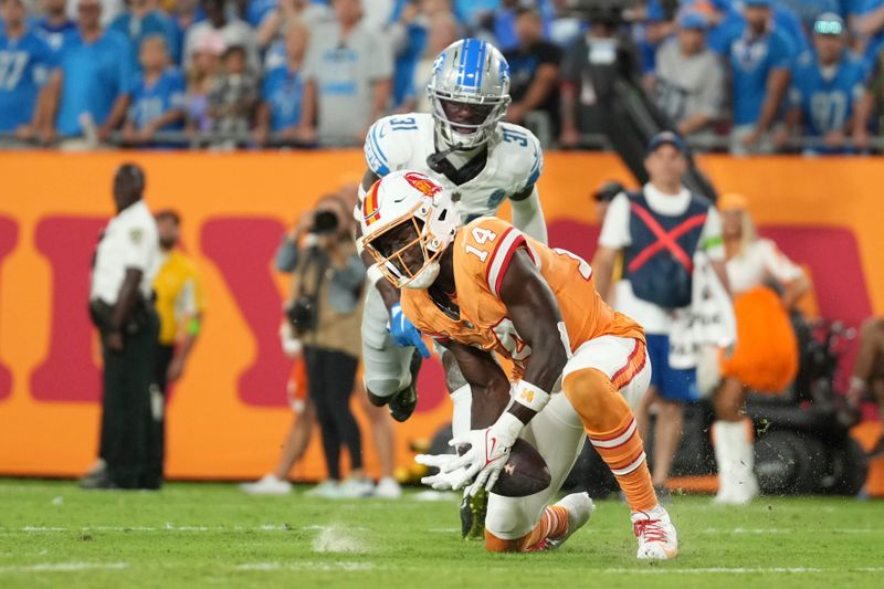 Tampa Bay Buccaneers wide receiver Chris Godwin (14) can't hold on to the ball with seconds remaining as Detroit Lions safety Kerby Joseph (31) defends in the fourth quarter during an NFL football game, Sunday, Oct. 15 2023, in Tampa, Fla. (AP Photo/Peter Joneleit)