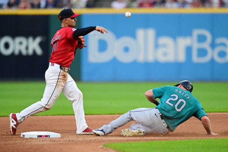 Jun 19, 2024; Cleveland, Ohio, USA; Cleveland Guardians second baseman Andres Gimenez (0) forces out Seattle Mariners left fielder Luke Raley (20) and turns the double play during the seventh inning at Progressive Field. Mandatory Credit: Ken Blaze-USA TODAY Sports