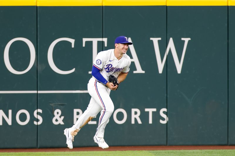 Sep 4, 2024; Arlington, Texas, USA; Texas Rangers outfielder Wyatt Langford (36) makes a catch at the wall to end the game between the Texas Rangers and New York Yankees at Globe Life Field. Mandatory Credit: Andrew Dieb-Imagn Images