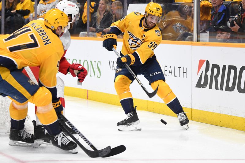 Mar 23, 2024; Nashville, Tennessee, USA; Nashville Predators defenseman Roman Josi (59) hits the puck out of the defensive zone during the second period against the Detroit Red Wings at Bridgestone Arena. Mandatory Credit: Christopher Hanewinckel-USA TODAY Sports