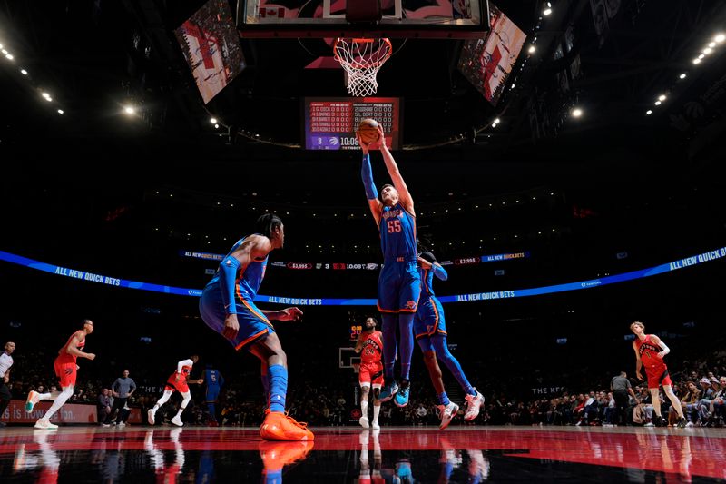 TORONTO, CANADA - DECEMBER 05:  Isaiah Hartenstein #55 of the Oklahoma City Thunder grabs the rebound during the game against the Toronto Raptors on December 05, 2024 at the Scotiabank Arena in Toronto, Ontario, Canada.  NOTE TO USER: User expressly acknowledges and agrees that, by downloading and or using this Photograph, user is consenting to the terms and conditions of the Getty Images License Agreement.  Mandatory Copyright Notice: Copyright 2024 NBAE (Photo by Mark Blinch/NBAE via Getty Images)