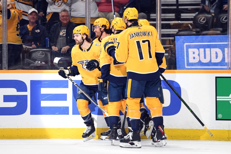 Apr 9, 2024; Nashville, Tennessee, USA; Nashville Predators center Tommy Novak (82) celebrates with teammates after a goal during the first period against the Winnipeg Jets at Bridgestone Arena. Mandatory Credit: Christopher Hanewinckel-USA TODAY Sports