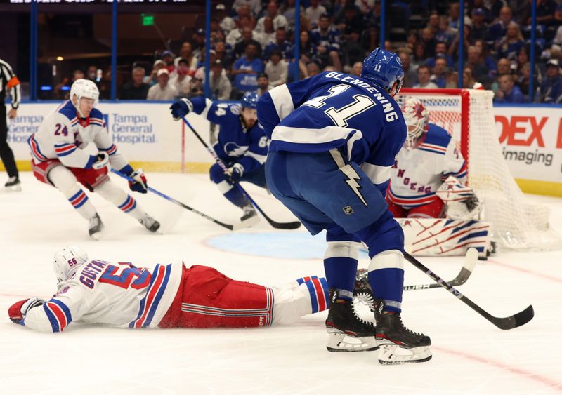 Mar 14, 2024; Tampa, Florida, USA; Tampa Bay Lightning center Luke Glendening (11) shoots as New York Rangers defenseman Erik Gustafsson (56) and goaltender Igor Shesterkin (31) defend during the first period at Amalie Arena. Mandatory Credit: Kim Klement Neitzel-USA TODAY Sports