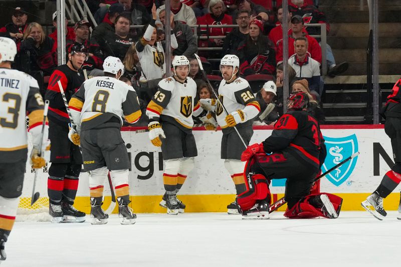 Mar 11, 2023; Raleigh, North Carolina, USA; Vegas Golden Knights center Paul Cotter (43) is congratulated by center Chandler Stephenson (20) and right wing Phil Kessel (8) after his goal past Carolina Hurricanes goaltender Frederik Andersen (31) during the third period at PNC Arena. Mandatory Credit: James Guillory-USA TODAY Sports