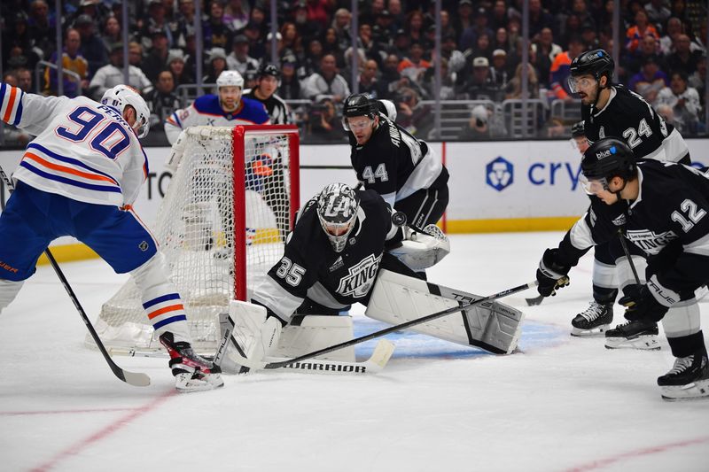 Apr 29, 2025; Los Angeles, California, USA; Los Angeles Kings goaltender Darcy Kuemper (35) blocks a shot against Edmonton Oilers right wing Corey Perry (90) during the first period in game five of the first round of the 2025 Stanley Cup Playoffs at Crypto.com Arena. Mandatory Credit: Gary A. Vasquez-Imagn Images