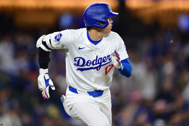 Apr 3, 2024; Los Angeles, California, USA; Los Angeles Dodgers designated hitter Shohei Ohtani (17) runs out a fly ball against the San Francisco Giants during the fourth inning at Dodger Stadium. Mandatory Credit: Gary A. Vasquez-USA TODAY Sports