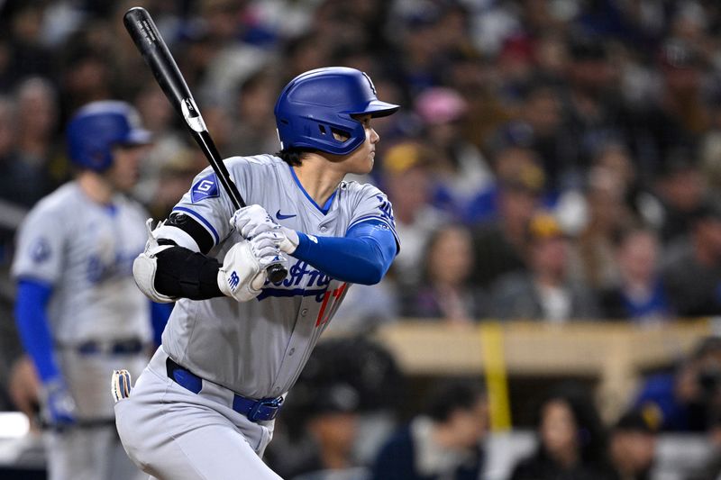 May 10, 2024; San Diego, California, USA; Los Angeles Dodgers designated hitter Shohei Ohtani (17) hits a double against the San Diego Padres during the eighth inning at Petco Park. Mandatory Credit: Orlando Ramirez-USA TODAY Sports