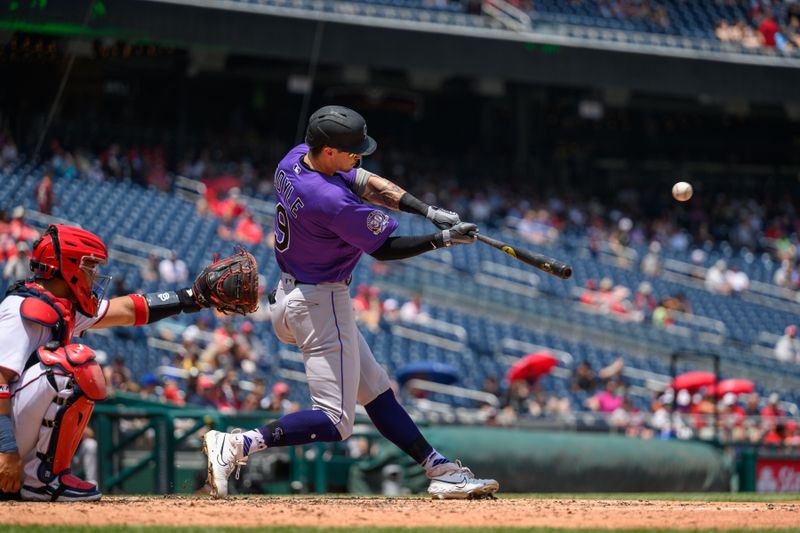 Jul 26, 2023; Washington, District of Columbia, USA; Colorado Rockies center fielder Brenton Doyle (9) hits a pitch during the fourth inning against the Washington Nationals at Nationals Park. Mandatory Credit: Reggie Hildred-USA TODAY Sports