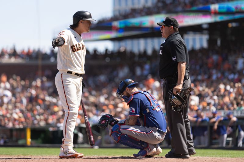 Aug 13, 2023; San Francisco, California, USA; San Francisco Giants first baseman Wilmer Flores (41) reacts to umpire Doug Eddings (88) during the ninth inning against the Texas Rangers at Oracle Park. Mandatory Credit: Stan Szeto-USA TODAY Sports