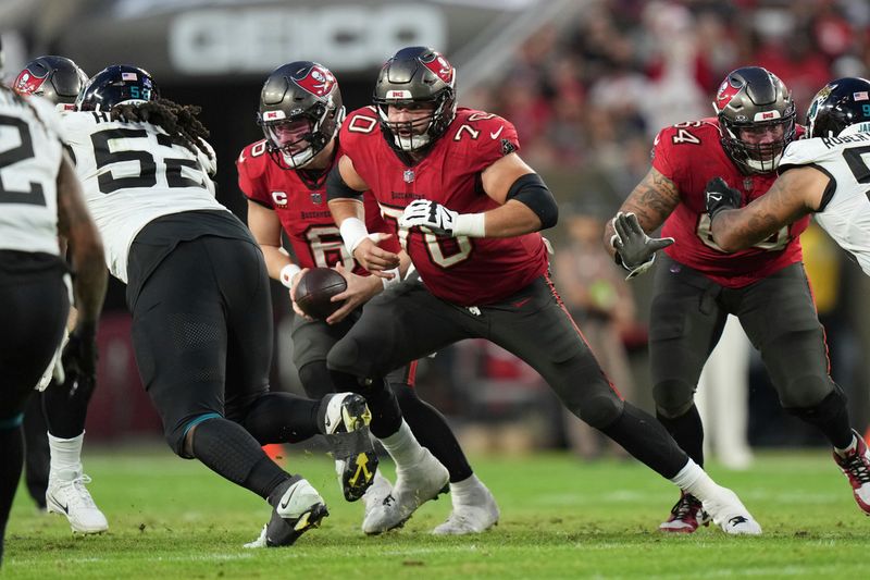 Tampa Bay Buccaneers center Robert Hainsey (70) run blocks during an NFL football game against the Jacksonville Jaguars, Sunday, Dec. 24, 2023, in Tampa, Fla. (AP Photo/Peter Joneleit)