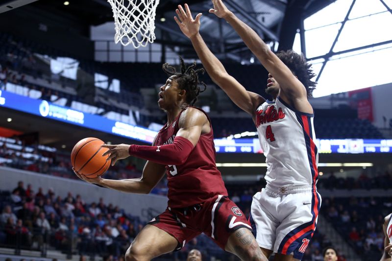 Feb 11, 2023; Oxford, Mississippi, USA; South Carolina Gamecocks guard Meechie Johnson (5) drives to the basket as Mississippi Rebels forward Jaemyn Brakefield (4) defends during the first half at The Sandy and John Black Pavilion at Ole Miss. Mandatory Credit: Petre Thomas-USA TODAY Sports