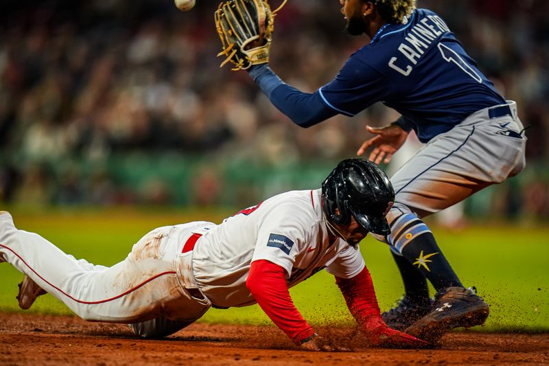 Sep 26, 2023; Boston, Massachusetts, USA; Boston Red Sox second baseman Enmanuel Valdez (47) tagged out at third base by Tampa Bay Rays third baseman Junior Caminero (1) in the third inning at Fenway Park. Mandatory Credit: David Butler II-USA TODAY Sports