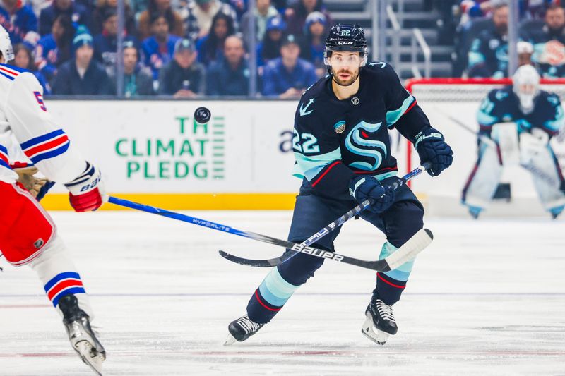 Nov 17, 2024; Seattle, Washington, USA; Seattle Kraken right wing Oliver Bjorkstrand (22) flips the puck ahead against the New York Rangers during the first period at Climate Pledge Arena. Mandatory Credit: Joe Nicholson-Imagn Images