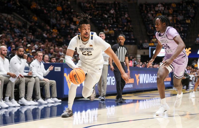 Jan 9, 2024; Morgantown, West Virginia, USA; West Virginia Mountaineers forward Josiah Harris (22) drives against Kansas State Wildcats forward Arthur Kaluma (24) during the second half at WVU Coliseum. Mandatory Credit: Ben Queen-USA TODAY Sports