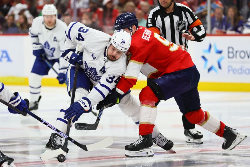 Apr 16, 2024; Sunrise, Florida, USA; Toronto Maple Leafs center Auston Matthews (34) and Florida Panthers center Sam Bennett (9) face-off during the third period at Amerant Bank Arena. Mandatory Credit: Sam Navarro-USA TODAY Sports