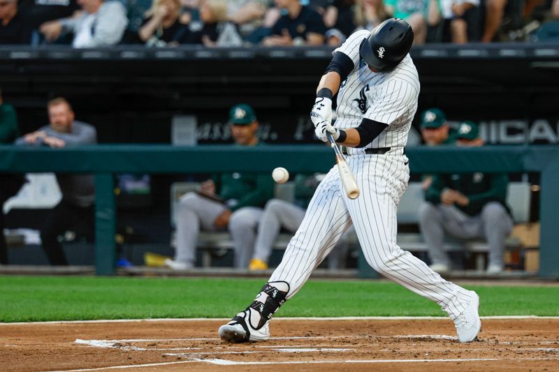 Sep 14, 2024; Chicago, Illinois, USA; Chicago White Sox outfielder Gavin Sheets (32) hits a single against the Oakland Athletics during the first inning at Guaranteed Rate Field. Mandatory Credit: Kamil Krzaczynski-Imagn Images