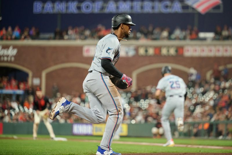 Aug 31, 2024; San Francisco, California, USA; Miami Marlins infielder Otto Lopez (61) scores a run against the San Francisco Giants during the seventh inning at Oracle Park. Mandatory Credit: Robert Edwards-USA TODAY Sports