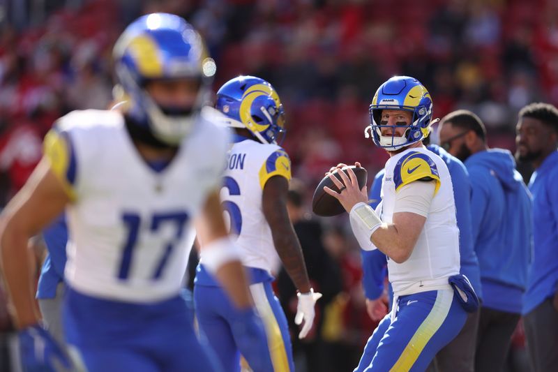 Los Angeles Rams quarterback Carson Wentz, right, and wide receiver Puka Nacua (17) warm up before an NFL football game against the San Francisco 49ers in Santa Clara, Calif., Sunday, Jan. 7, 2024. (AP Photo/Jed Jacobsohn)