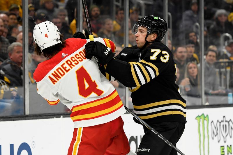 Feb 6, 2024; Boston, Massachusetts, USA; Boston Bruins defenseman Charlie McAvoy (73) shoves Calgary Flames defenseman Rasmus Andersson (4) during the third period at TD Garden. Mandatory Credit: Bob DeChiara-USA TODAY Sports