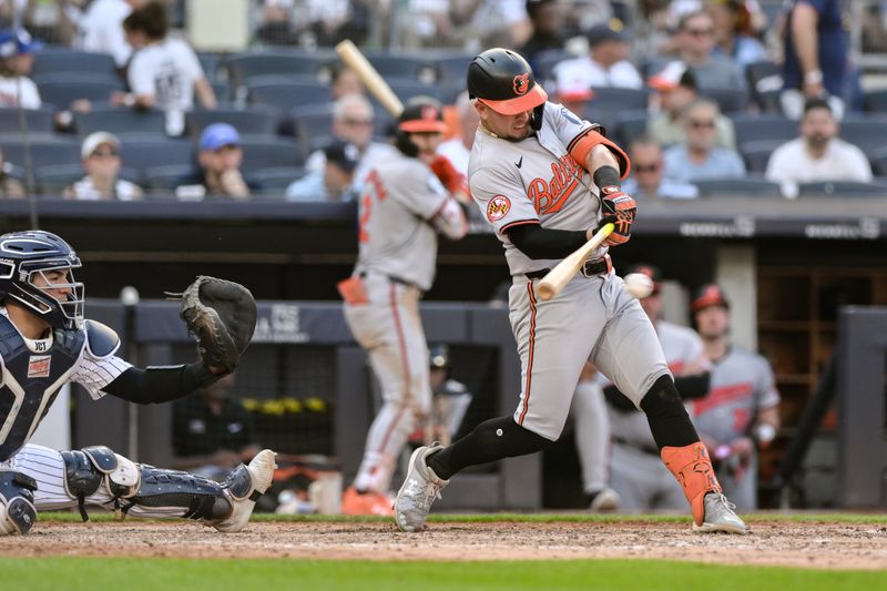 Jun 20, 2024; Bronx, New York, USA; Baltimore Orioles third baseman Ramon Urias (29) hits a single against the New York Yankees during the sixth inning at Yankee Stadium. Mandatory Credit: John Jones-USA TODAY Sports