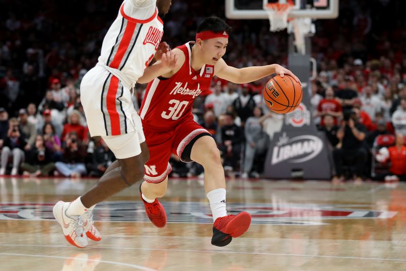 Feb 29, 2024; Columbus, Ohio, USA;  Nebraska Cornhuskers guard Keisei Tominaga (30) dribbles past Ohio State Buckeyes guard Dale Bonner (4) during the first half at Value City Arena. Mandatory Credit: Joseph Maiorana-USA TODAY Sports