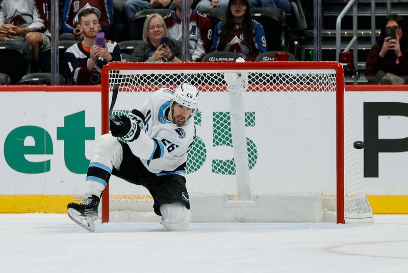 Sep 21, 2025; Denver, Colorado, USA; Utah Mammoth defenseman Dmitri Simashev (26) clears the puck from in front of an open net in the third period against the Colorado Avalanche at Ball Arena. Mandatory Credit: Isaiah J. Downing-Imagn Images