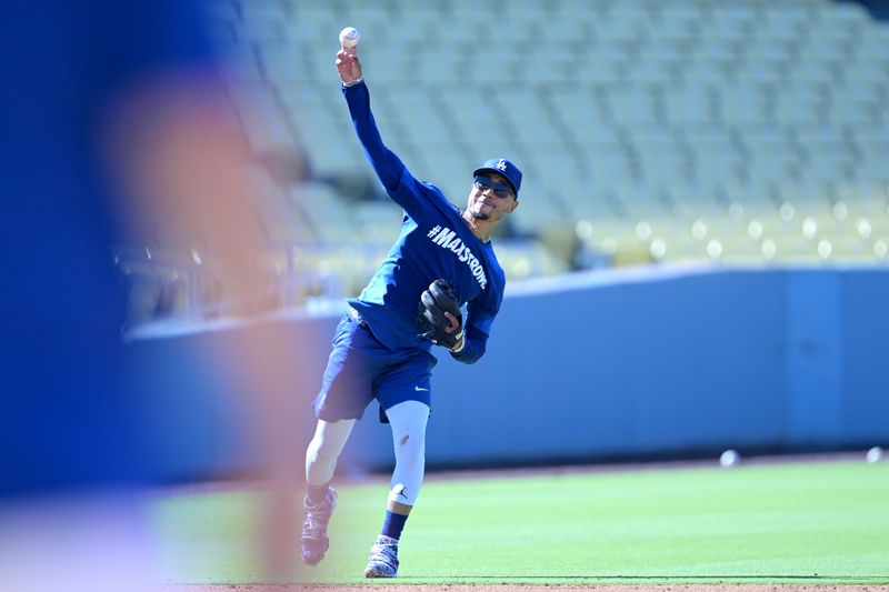 Aug 5, 2024; Los Angeles, California, USA;  Los Angeles Dodgers second baseman Mookie Betts (50) fields ground balls prior to the game against the Philadelphia Phillies at Dodger Stadium. Dodger players wore #MaxStrong shirts during pregame to honor Max, the 3-year old son of first baseman Freddie Freeman (5), who was diagnosed with Guillian-Barre syndrome. Mandatory Credit: Jayne Kamin-Oncea-USA TODAY Sports