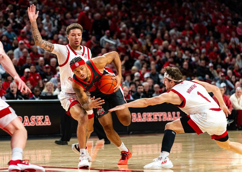 Jan 23, 2024; Lincoln, Nebraska, USA; Ohio State Buckeyes guard Roddy Gayle Jr. (1) drives against Nebraska Cornhuskers guard Eli Rice (11) and guard Sam Hoiberg (1) during the second half at Pinnacle Bank Arena. Mandatory Credit: Dylan Widger-USA TODAY Sports