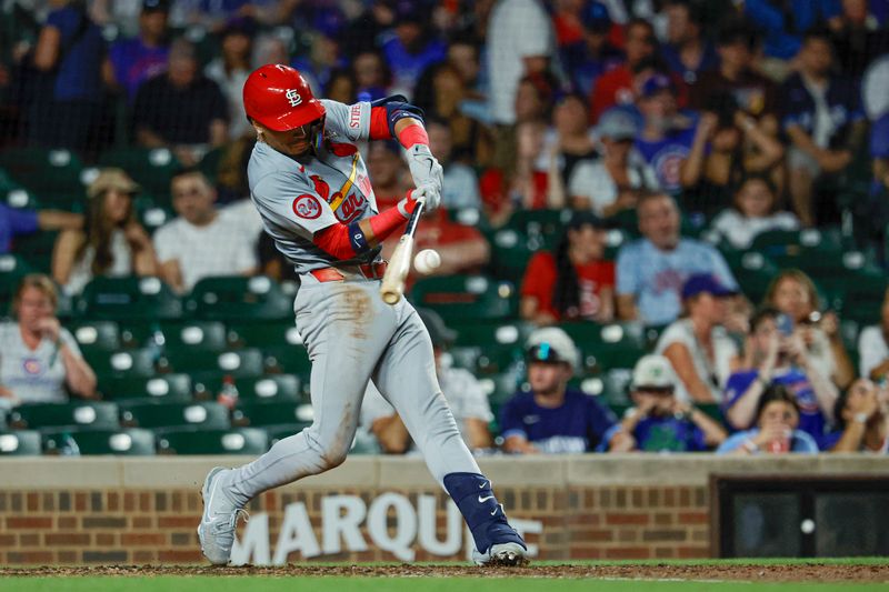 Aug 1, 2024; Chicago, Illinois, USA; St. Louis Cardinals shortstop Masyn Winn (0) hits a two-run home run against the Chicago Cubs during the seventh inning at Wrigley Field. Mandatory Credit: Kamil Krzaczynski-USA TODAY Sports