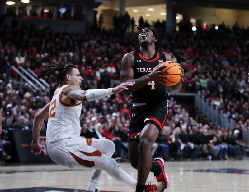 Feb 13, 2023; Lubbock, Texas, USA;  Texas Tech Red Raiders forward Robert Jennings (4) gets tangled up with Texas Longhorns forward Christian Bishop (32) in the first half at United Supermarkets Arena. Mandatory Credit: Michael C. Johnson-USA TODAY Sports